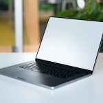 A sleek laptop with an empty display on a table in a modern workspace